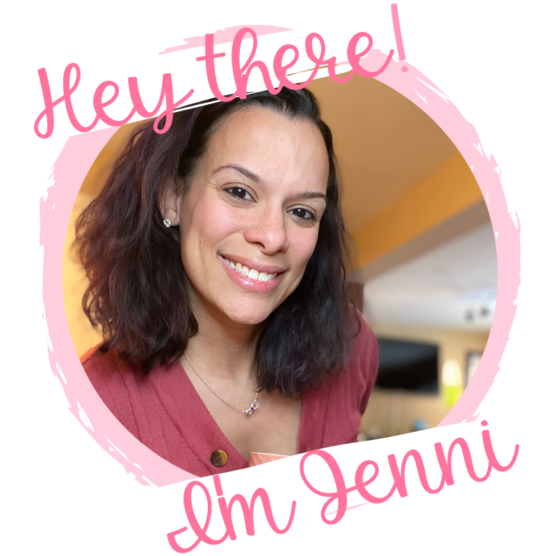 Jenni in a dark coral sweater, leaning in, smiling. The wording around the image says Hey There I'm Jenni.