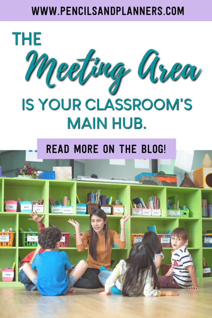 teacher sitting on the floor in front of green bookshelved classroom library teaching small group of 5 students text overlay says the meeting area is your classroom's main hub read more on the blog