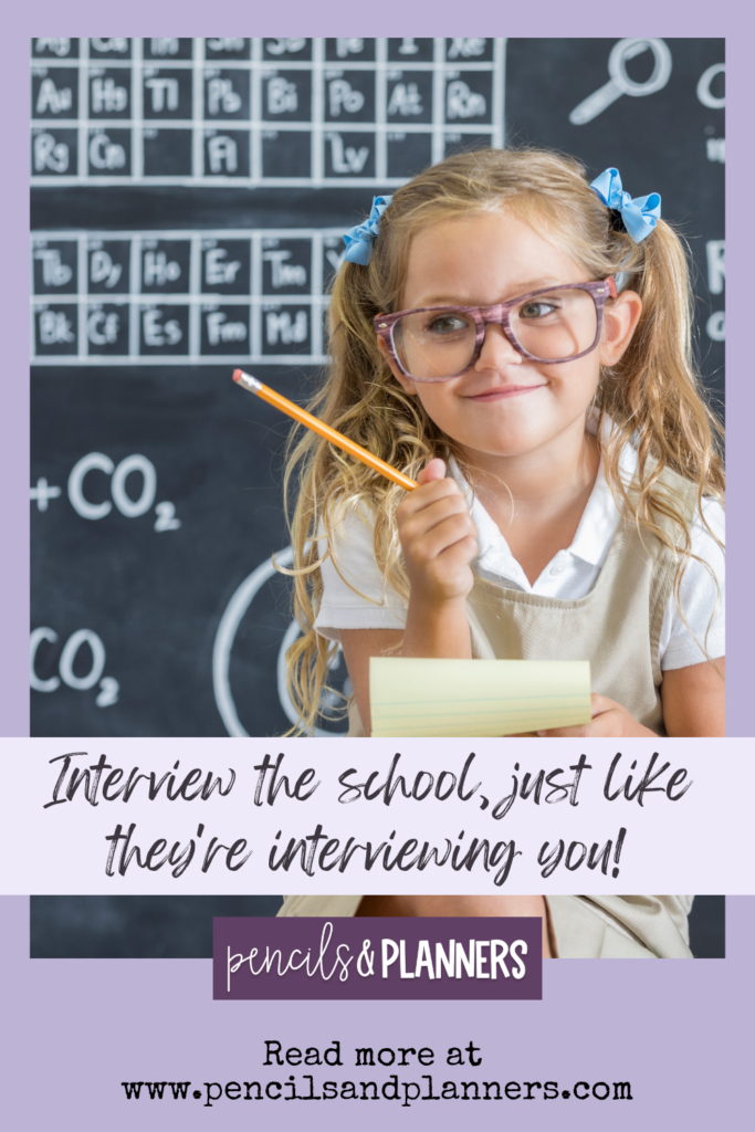 image of a little girl with blond hair in pigtails two light blue bows and glasses she is holding a pencils and a yellow lined notepad smiling behind her is a black chalkboard with part of the periodic table of elements visible the text says interview the school just like they are interviewing you