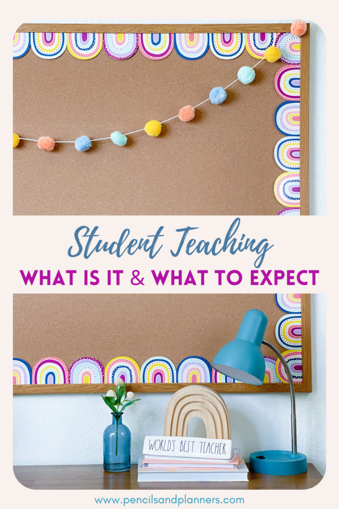 Simple bulletin board with light brown background paper, pastel boho rainbows and pom pom garland, the teacher's desk has a small blue vase with two small flowers, a few books in a pile, a wooden rainbow on top, and a plaque that says world's best teacher, the text overlay says student teaching what is it and what to expect, there is also a small blue desk lamp