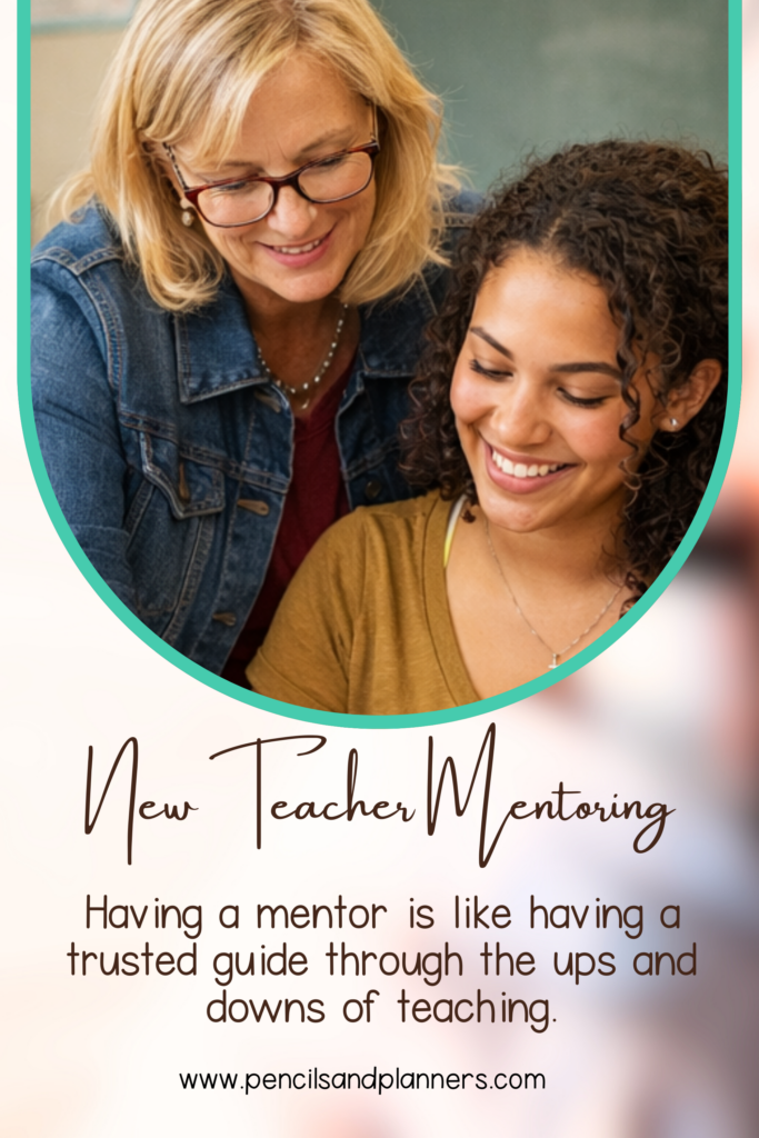 mentor standing over new teacher smiling and looking down